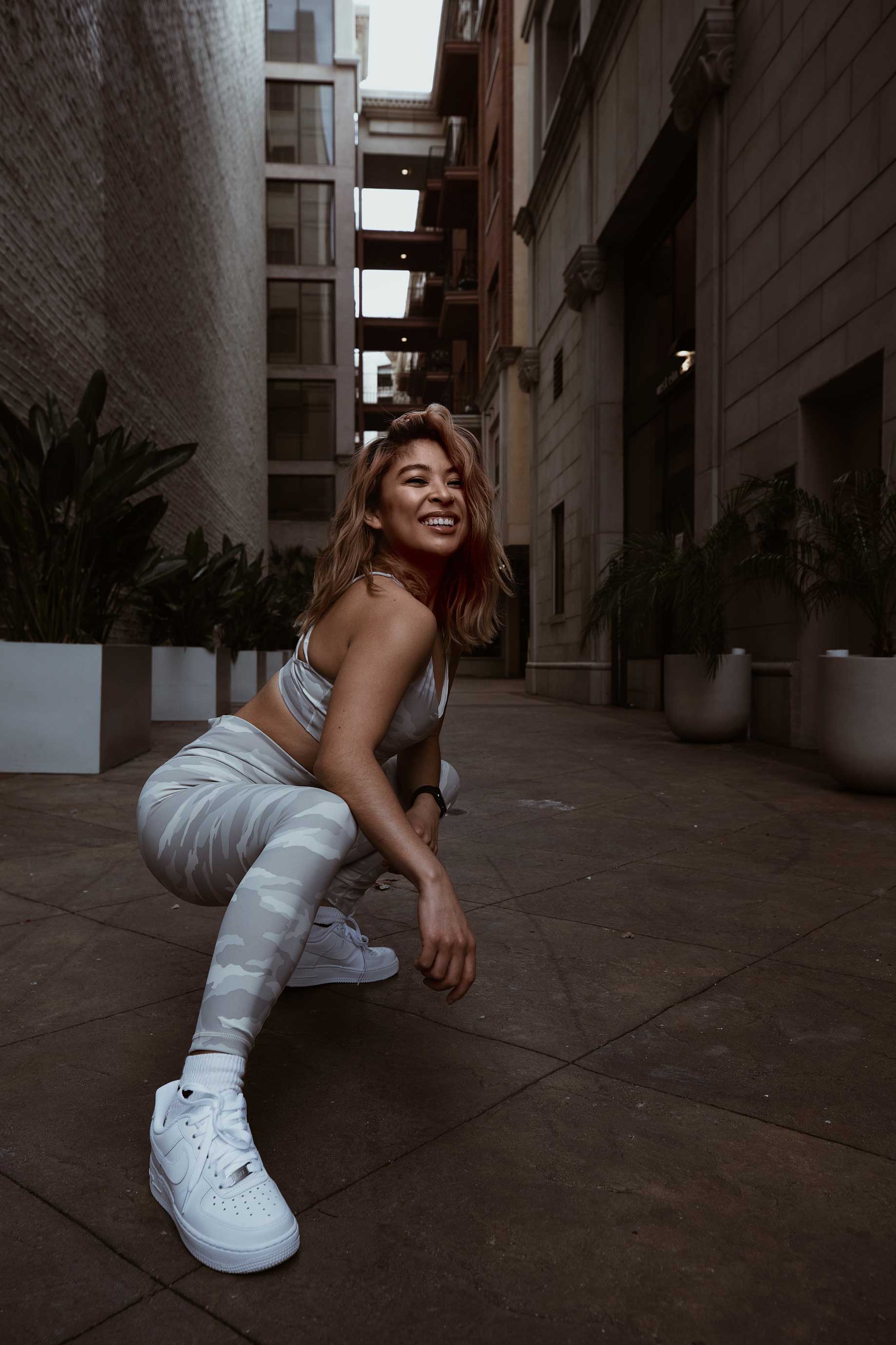 Leah crouching down infront of the camera on the street